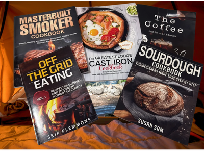 Collection of cookbooks including Masterbuilt Smoker, Cast Iron, Sourdough, Off the Grid Eating, and Coffee table recipes