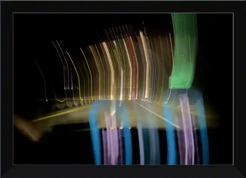 Abstract light trails at night, colorful motion blur in a framed print