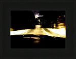 Night driving scene with glowing headlights on wet road, framed print