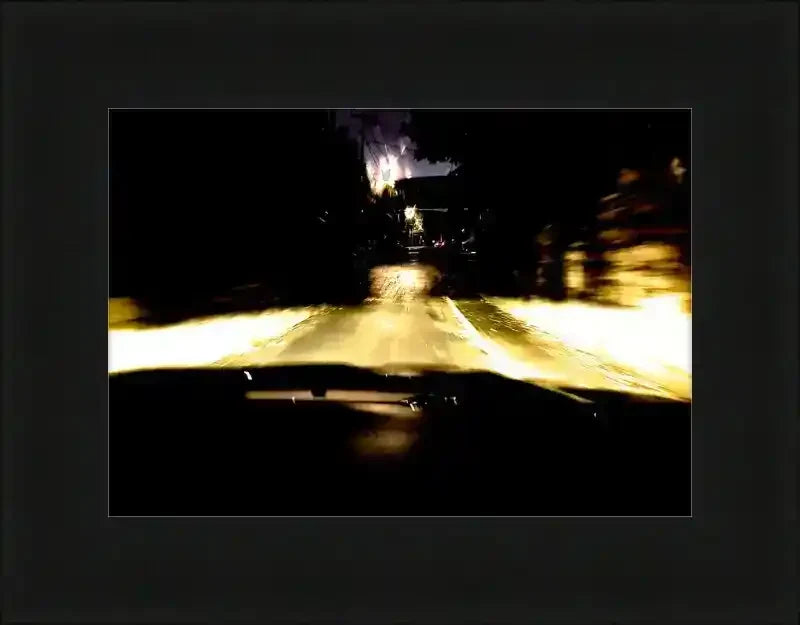 Night driving scene with glowing headlights on wet road, framed print