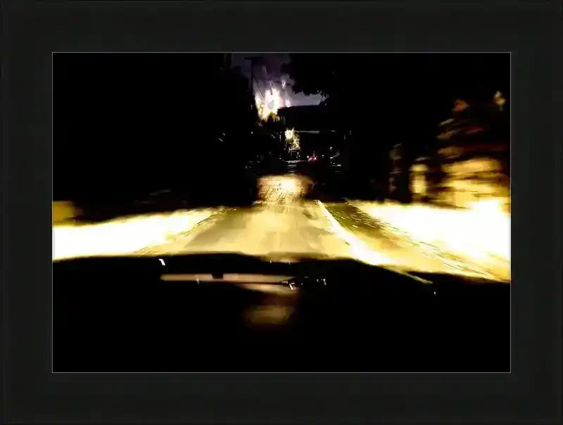 Night driving scene with blurred headlights and streetlights, framed print of original photography
