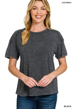 Woman wearing a black acid-wash t-shirt on a white background