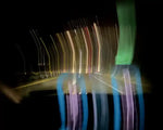 Long exposure night road with colorful light trails and reflections
