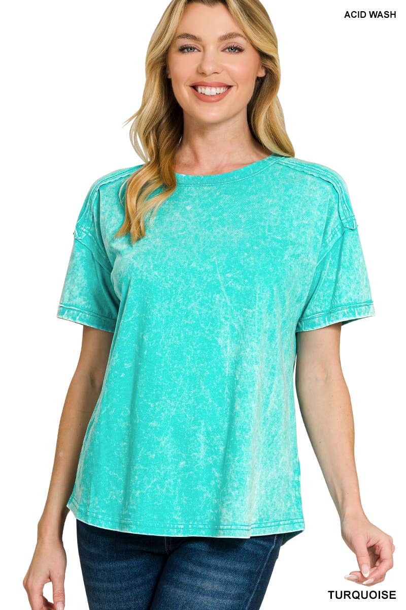 Woman wearing a turquoise acid wash t-shirt on a white background