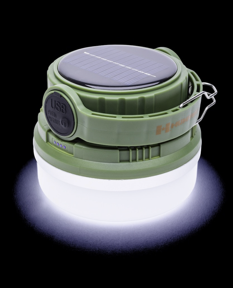 Green camping lantern with solar panel on a black background