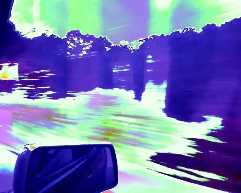 Vibrant abstract landscape with glowing green sky, purple trees, and car side mirror, artistic photo print
