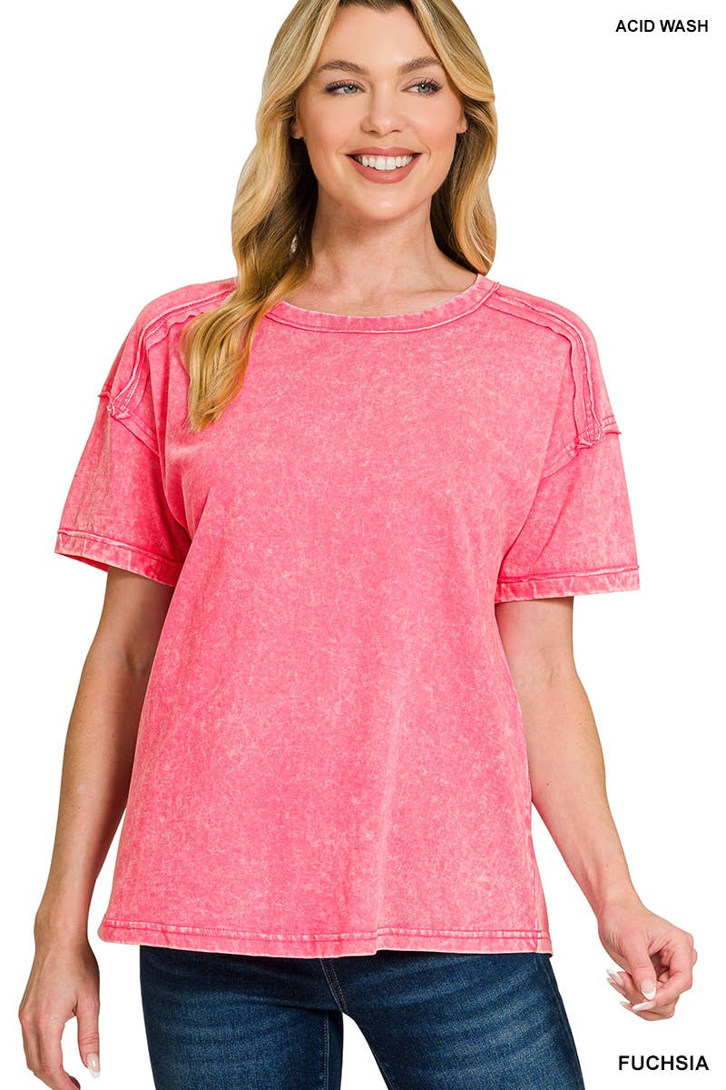 Woman wearing a pink acid wash t-shirt with text indicating color and style.