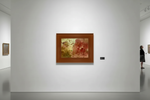 Abstract artwork in wooden frame displayed in modern gallery with visitors viewing art