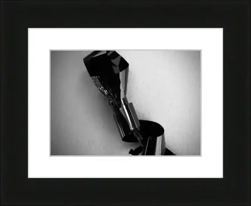 Black and white framed print of abstract metallic sculpture with reflective surfaces