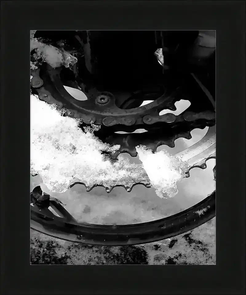 Snow-covered bicycle gear and chain in black and white, framed print