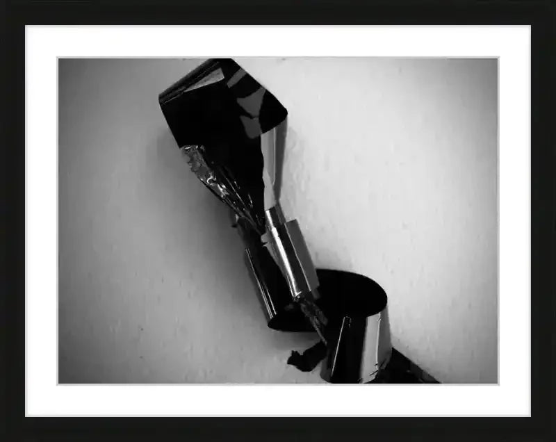 Black and white framed print of abstract metallic sculpture with reflective surfaces