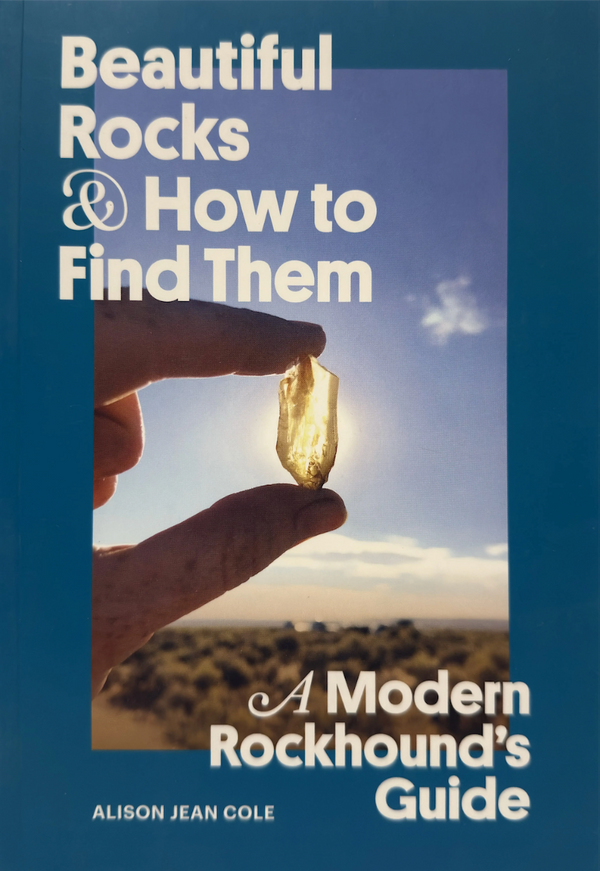 Book cover of 'Beautiful Rocks & How to Find Them' with a hand holding a crystal against a blue sky.
