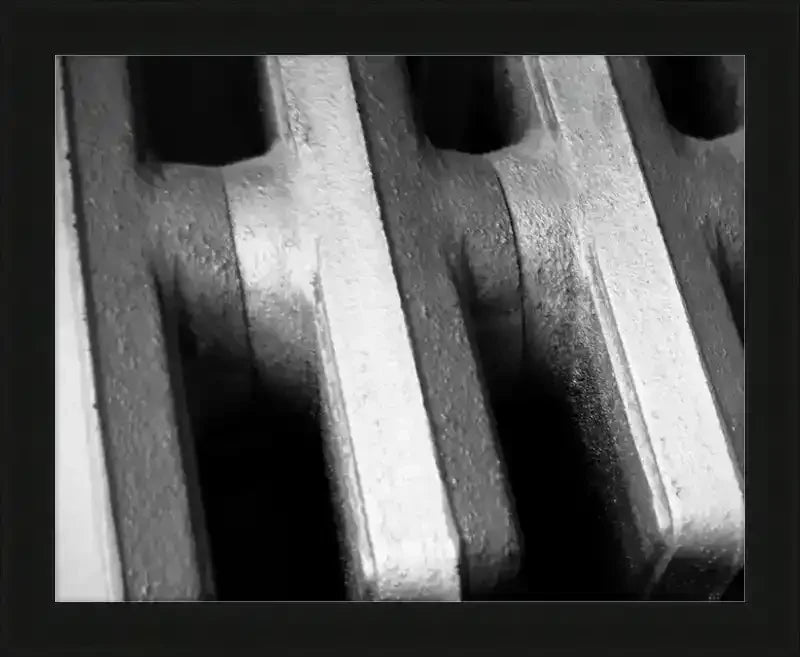 Black and white close-up of textured metal radiator fins, framed print
