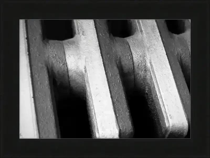 Black and white close-up of vintage radiator fins, textured metal details, framed art print