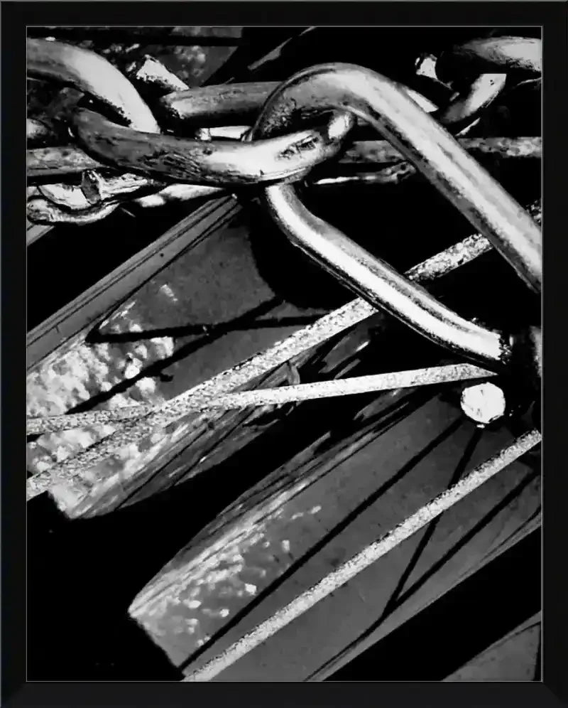 Black and white framed print of rustic metal chain links and weathered wood texture