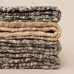 Stack of folded textured socks on a neutral background