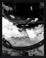 Snow-covered bicycle gear and chain in black and white, framed print