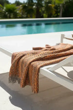 Close-up of a textured fabric with orange and black pattern