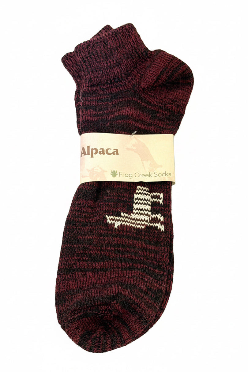 Pair of maroon alpaca socks with a visible brand label on a white background
