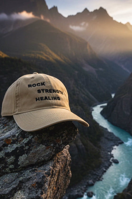 Beige cap with 'Rock Strength Healing' text on a white background