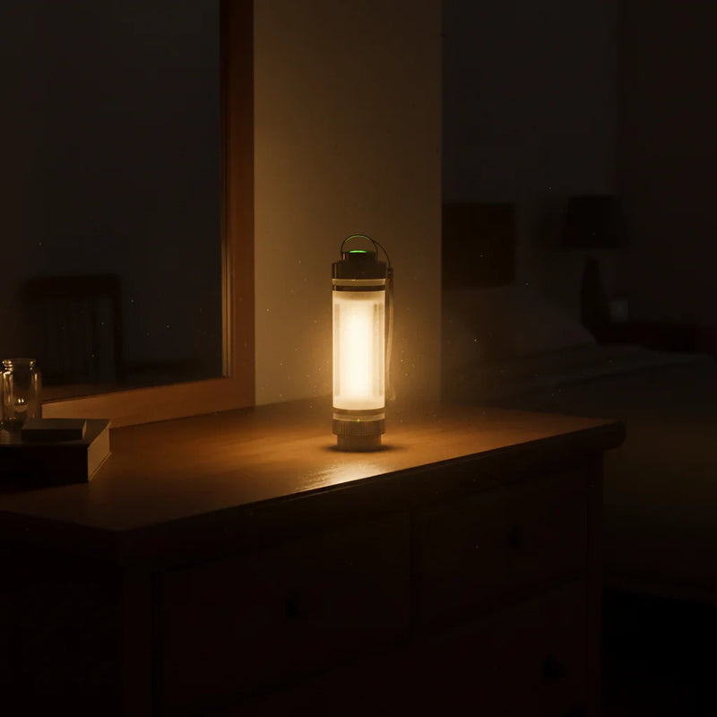 Glowing lantern on wooden dresser in dim room, warm ambient light