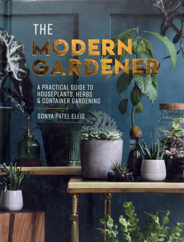 Book cover of 'The Modern Gardener' with plants and gardening items on a table.