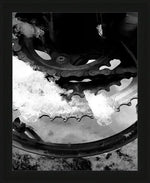 Snow-covered bicycle gear and chain in black and white, framed print