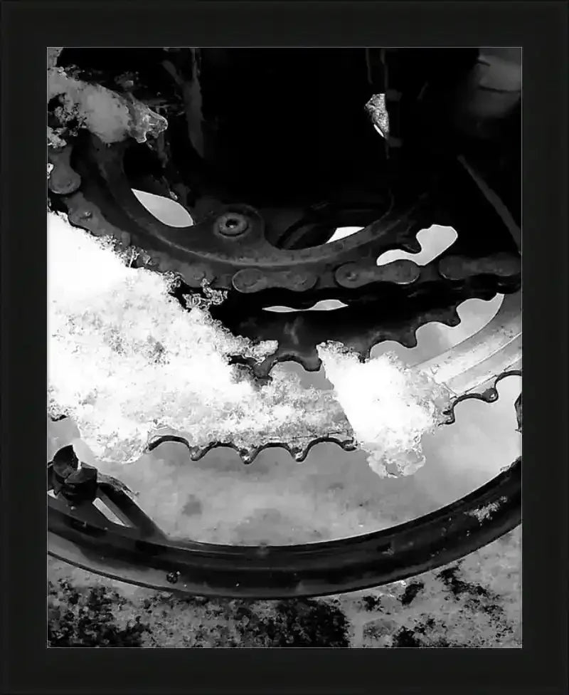 Snow-covered bicycle gear and chain in black and white, framed print