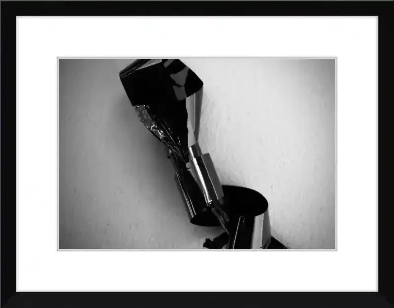 Black and white framed print of abstract metallic sculpture with reflective surfaces