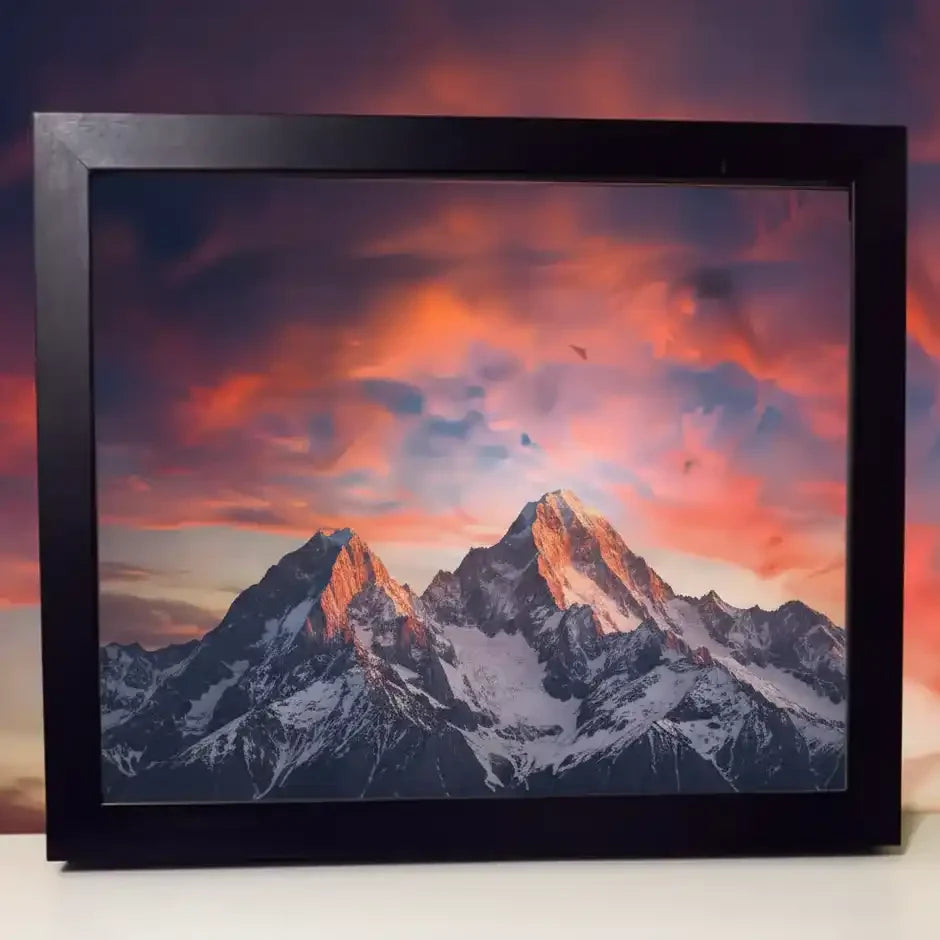 Framed mountain print with sunset sky, snow-capped peaks, dramatic clouds — nature photography wall art