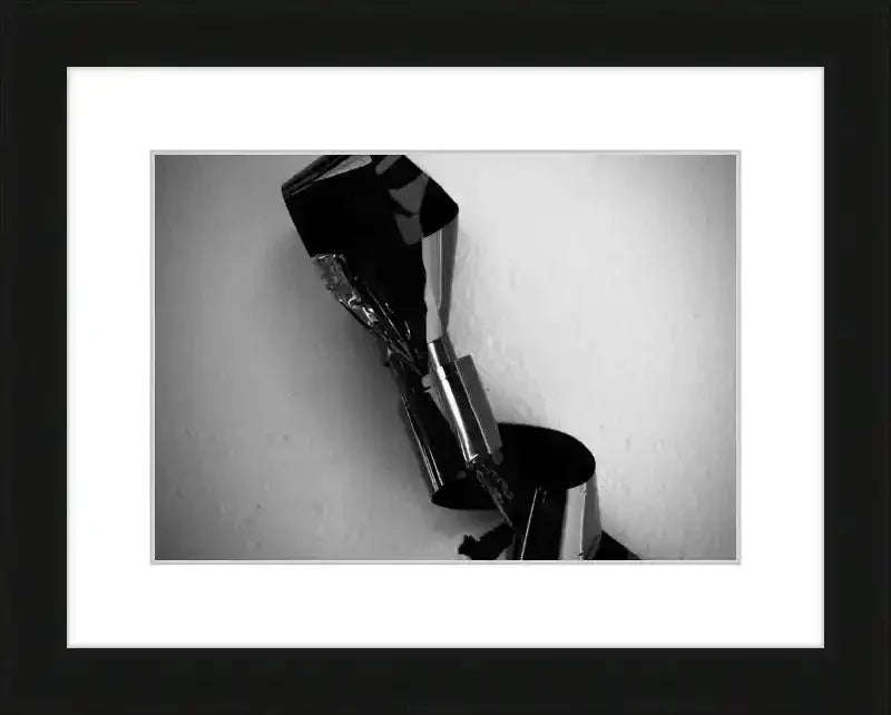 Black and white framed print of abstract metallic sculpture with reflective surfaces