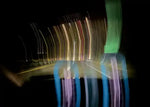 Long exposure night street with colorful light trails and reflections