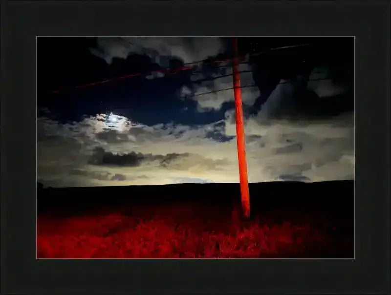 Framed night sky print with red utility pole, clouds, and moonlit horizon