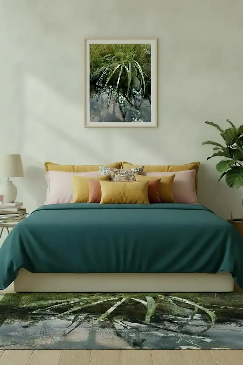 Framed nature print of green foliage above bed, matching rug, cozy bedroom decor with teal bedding and plants