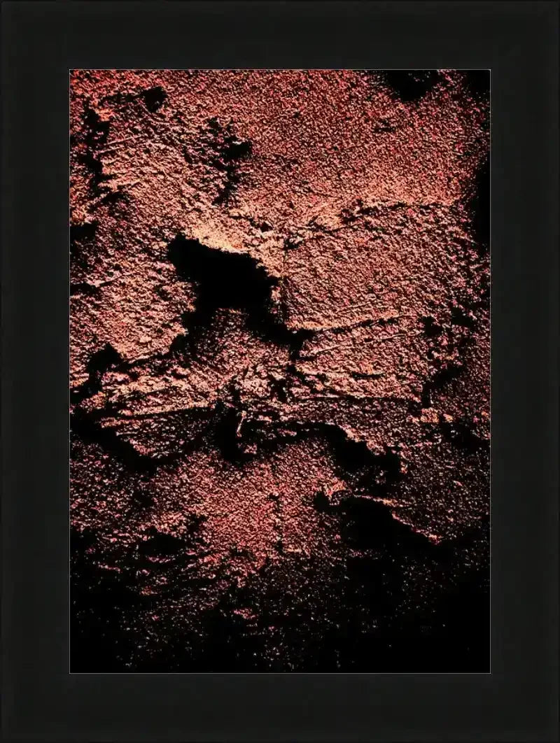 Textured abstract artwork in warm reds and blacks, framed in black, wall decor