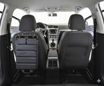 Gray car seat organizer with multiple pockets attached to front passenger seat, viewed from rear