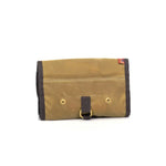 Brown leather rollup back with gold rivets and a black strap on a white background