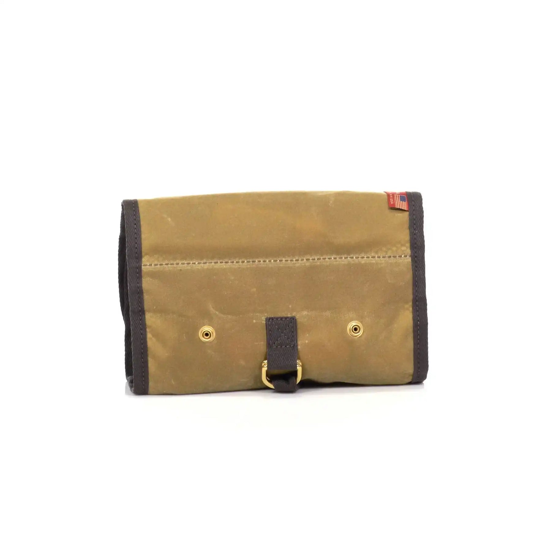 Brown leather rollup back with gold rivets and a black strap on a white background