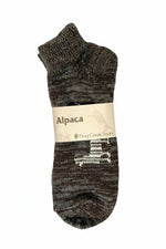 Alpaca socks with white pattern, labeled Frog Creek Socks, on white background