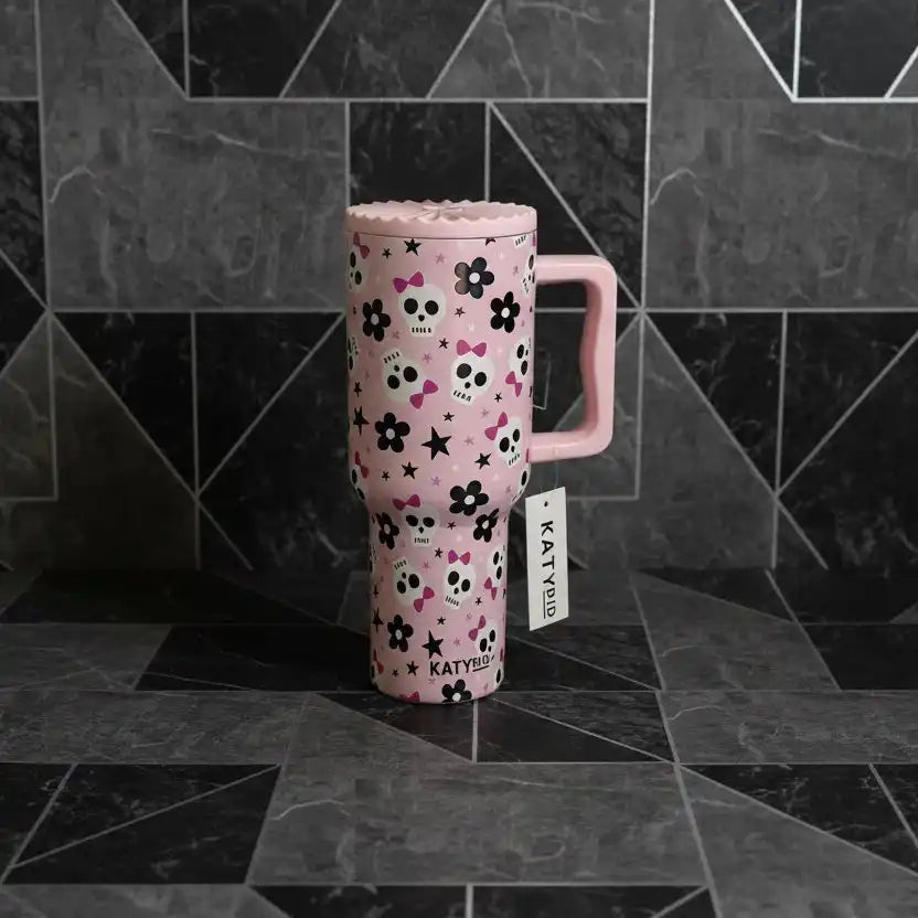Pink Tumbler with floral pattern and handle on a white surface Tumbler