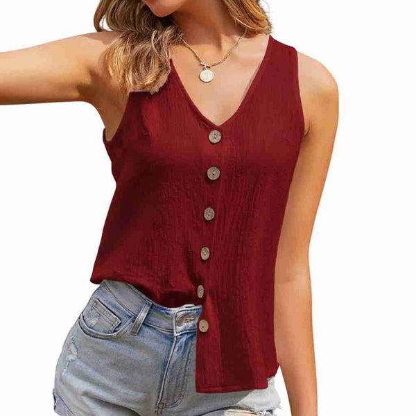 Woman wearing a red button-up tank top and denim shorts on a white background