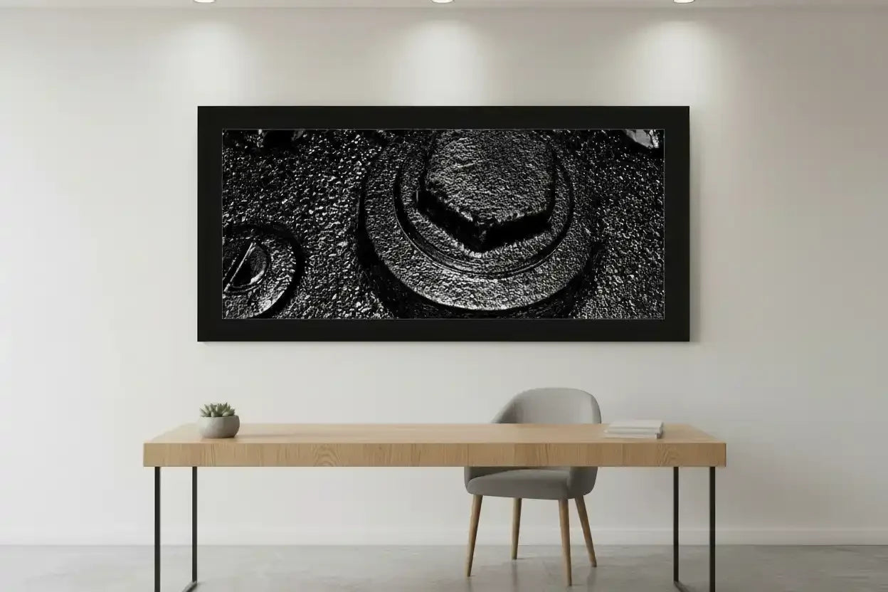 Black and white industrial texture wall art print in modern frame above desk