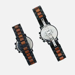 Two watches with wooden and black straps on a light gray background