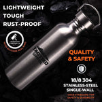 Stainless steel water bottle with Tagtiko Survival logo, lightweight and rust-proof, set on dark rocks