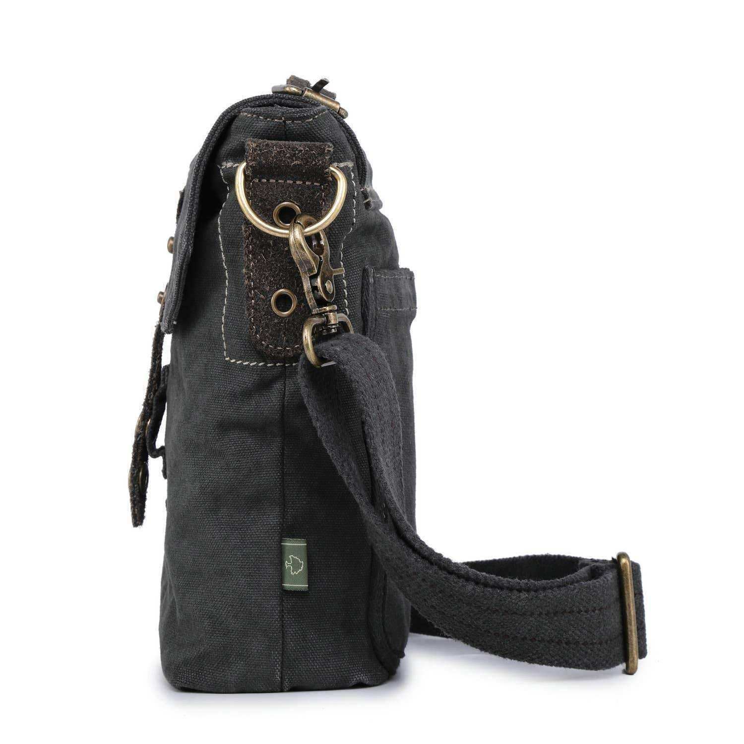 Dark canvas crossbody bag with adjustable strap, brass hardware, and leather accents
