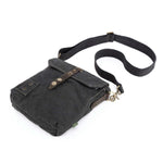 Black leather bag with a strap on a white background