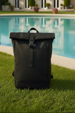 Woman with black roll-top backpack overlooking cityscape, ideal for travel and urban adventures.