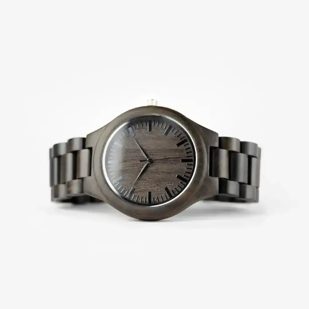 Dark wood grain watch with minimalist black dial and linked band on white background