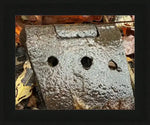 Rusty antique hinge with three holes, nestled among autumn leaves, natural texture close-up