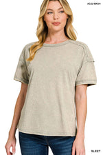 Woman wearing a beige acid wash t-shirt on a white background